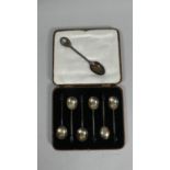 A Cased Set of Six Silver Coffee Spoon and a Silver Rifle Shooting Spoon