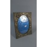 A Silver Plate on Copper Japanese Easel Back Photo Frame Decorated in Relief with Orchids, 27cm High