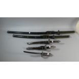 A Collection of Two Graduated Reproduction Samurai Swords and Three Dragon Handled Daggers