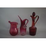 A Cranberry Glass Ewer and Two Jugs