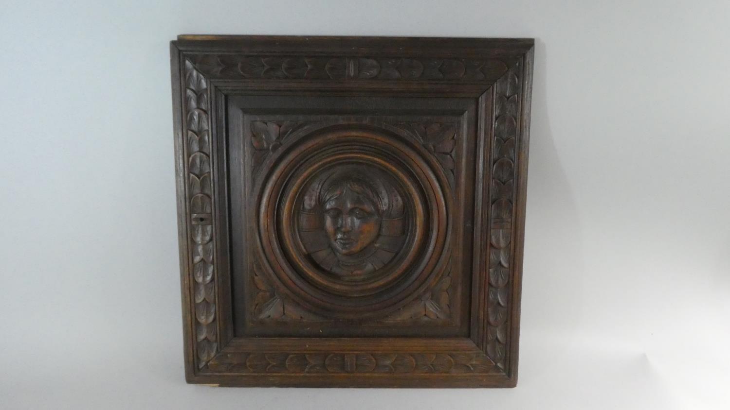 A Continental Wooden Panel Carved in Relief with Maiden's Head and Foliate Border Design, 52cm x