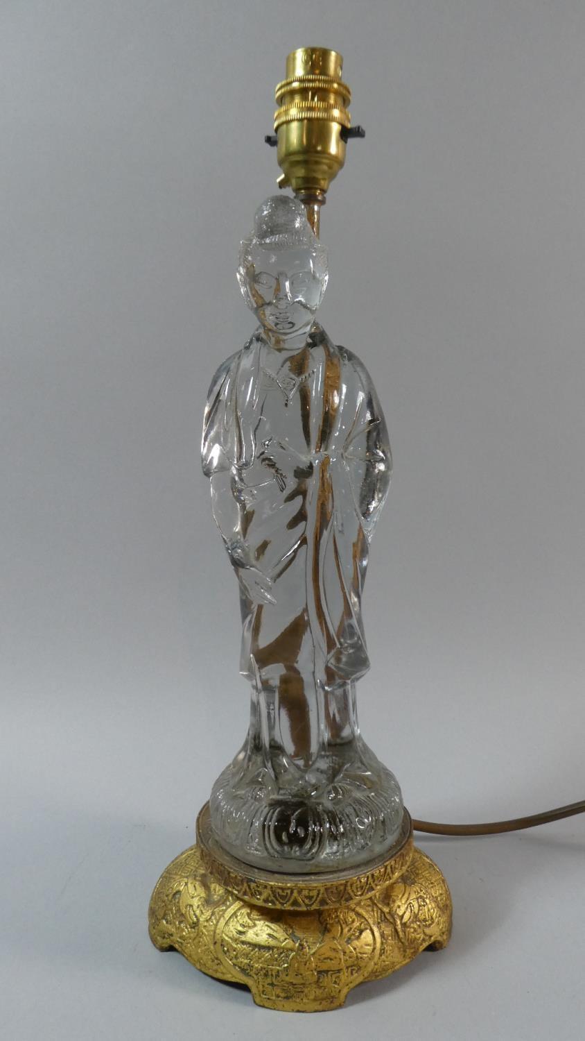 A Gilt Metal and Glass Figural Table Lamp in the Form of a Robed Elder. 38cms High