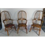 A Set of Three Mid 20th Century Hooped Spindle Back Arm Chairs with Pierced Splats and Leather Pad