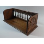 A Carved Oak Book Rest with Spindle Back and Floral Blind Carving to End Panels. 47cms Wide