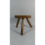 A George III Primitive Fruitwood Stool with an Octagonal Plank Top supported on Three Legs. 26cms