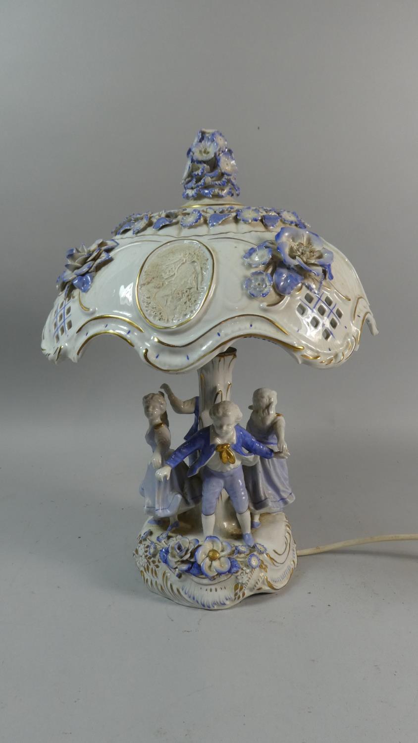 A Late 20th Century East German Porcelain Table Lamp in the Form of Children Playing Ring a Ring