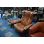 A Late 20th Century Swivel Reclining Leather Armchair and Matching Footstool