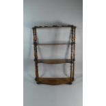 A 19th Century Set of Walnut Hanging Wall Shelves with Serpentine Fronted Shelves and Turned