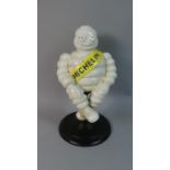 A Reproduction Painted Cast Metal Figure of a Seated Michelin Man, 28.5cm High (Plus VAT)