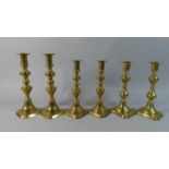 Three Pairs of Late 19th Century Brass Candle Sticks, All With Pushers, The Tallest 25cm high