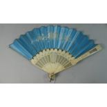 A 19th Century 16 Bladed Ivory and Silk Fan. Blue Silk Painted with Spray of Flowers and Etched