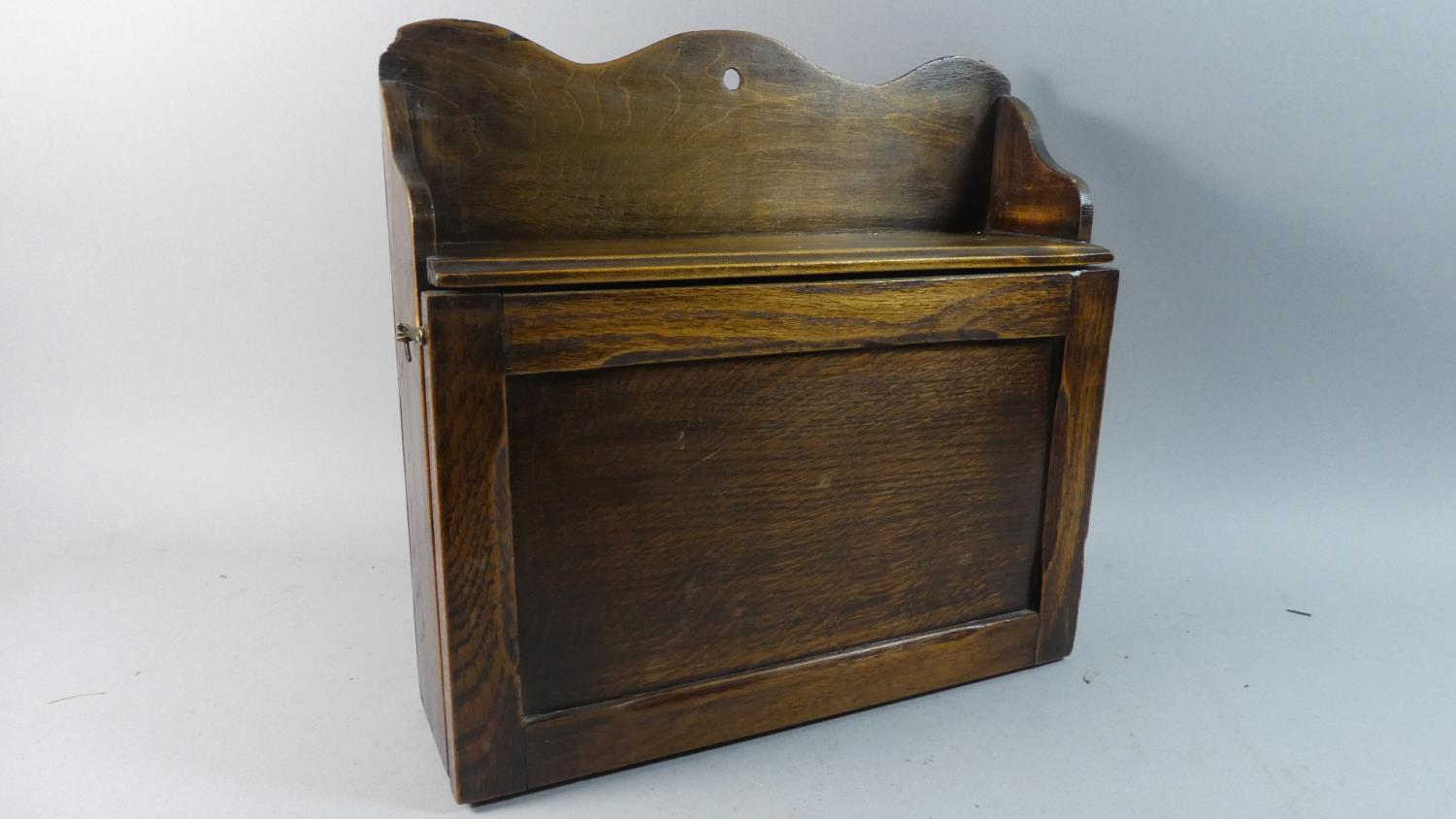 An Edwardian Oak Wall Hanging Sectioned Shelf Unit with Pull Down Front, 38cm Wide