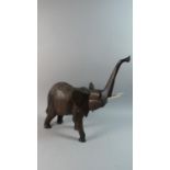 A Carved Wooden Study of an African Elephant with Trunk in Salute, 51cm High