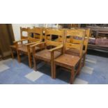 A Collection of Eight Pine Framed Hide Seated Ladder Back Chairs