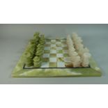 A Mid/Late 20th Century Onyx Chess Board and Complete Set of Chess Pieces, 41cm Square