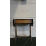An Edwardian Walnut Drop Leaf Lift Top Sewing Table with Turned Supports and Green Upholstered