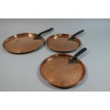 A Collection of Three Graduated Victorian Copper Saucepan Lids with Ion Handles, the Largest 26.