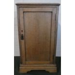 An Edwardian Oak Bedside Cabinet with Panelled Door