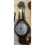 An Edwardian Oak Framed Wheel Barometer with Temperature Scale by J H Campbell & Co., Liverpool,