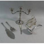 A Collection of Silverplate to Include Toast Rack, Fish Servers, Ladle, Three Branch Candelabra