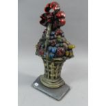 A Painted Cast Metal Doorstop in the Form of Wicker Basket of Fruit with Bow, 38cm High