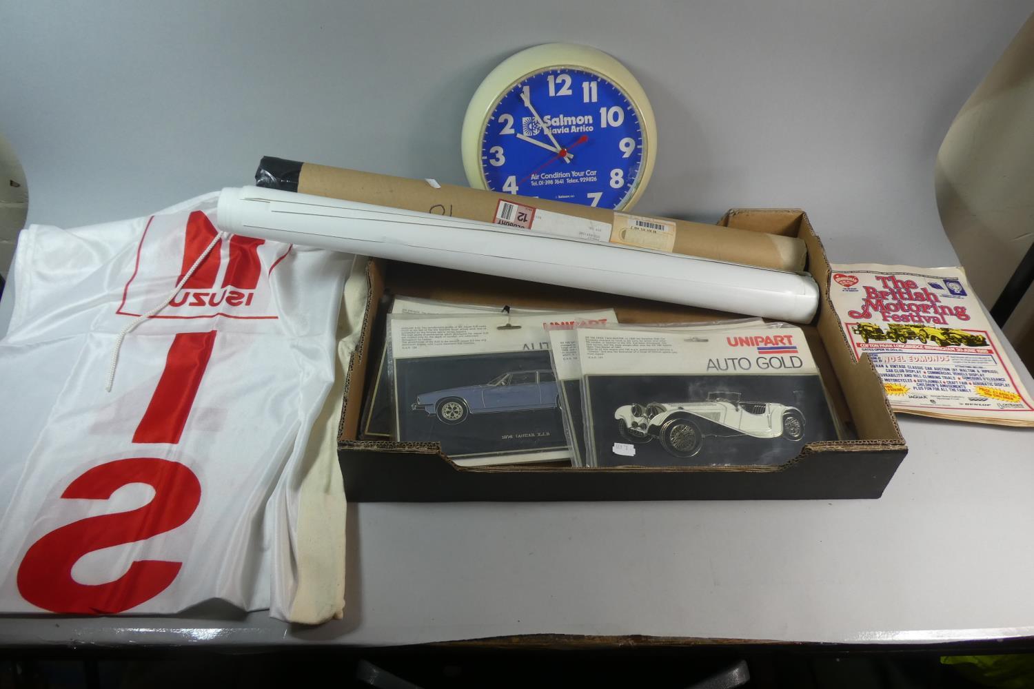 A Box Containing Isuzu Banner, Unipart Auto Gold Plaques, Vintage Wall Clock, Les Mans Posters etc