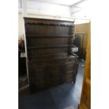 An Edwardian Oak Dresser, The Base with Three Drawers Over Cupboard with Carved Panel Doors, Two