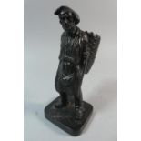 An Ebonised Cast Iron Vesta in the Form of a Fisherman with Carrying Basket, 17cm High