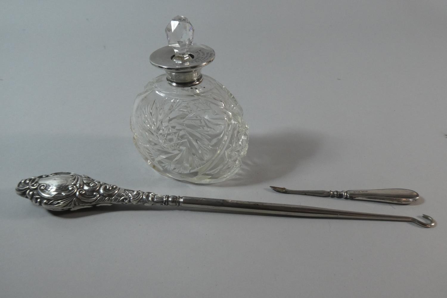 A Silver Mounted Glass Scent Bottle, Together with a Silver Handled Button Hook and Manicure Tool