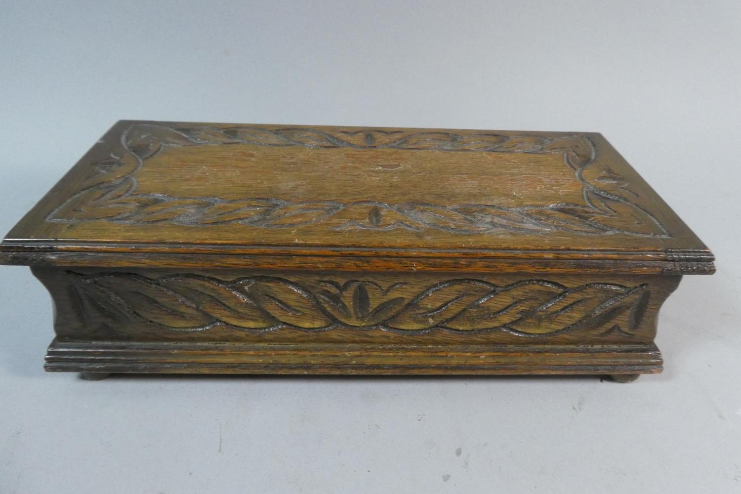 An Edwardian Oak Musical Cigar Box with Carved Hinged Lid, 24.5cm Wide - Image 2 of 3