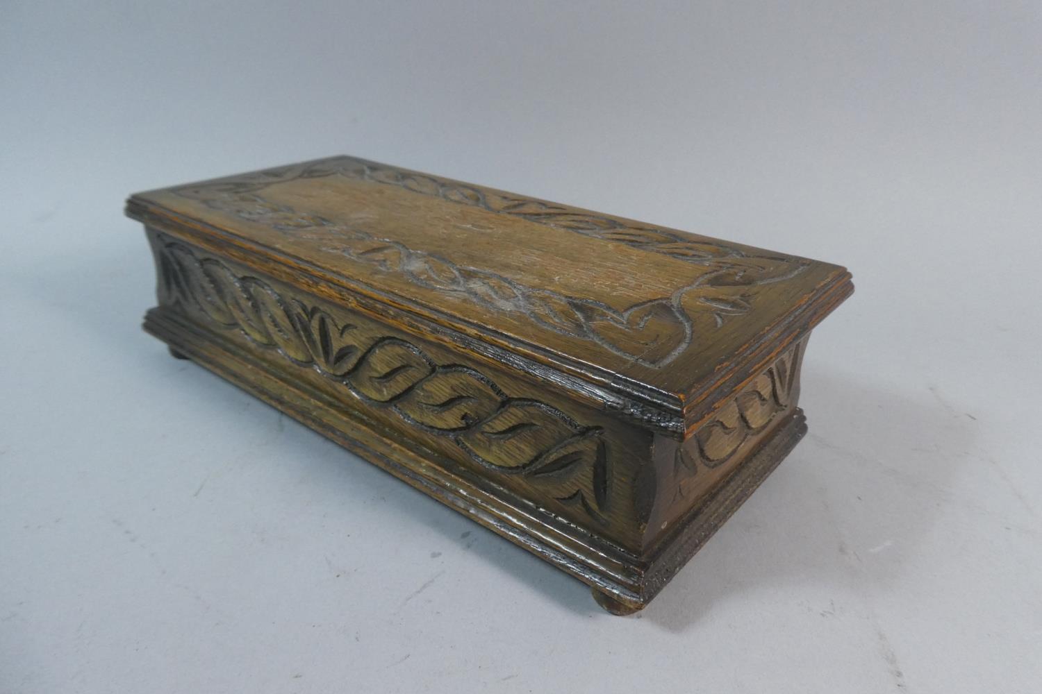 An Edwardian Oak Musical Cigar Box with Carved Hinged Lid, 24.5cm Wide