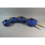 A Set of Four Blue Enamelled Le Creuset Lidded Saucepans