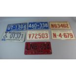 A Collection of Seven Pressed Reproduction Tinplate American Number Plates