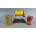 A Metal Desk Top Ribbon Dispenser Stand with Three Rolls of Ribbon