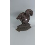 A Cast Metal Doorstop in the Form of Seated Squirrel with Nut, 26cm High