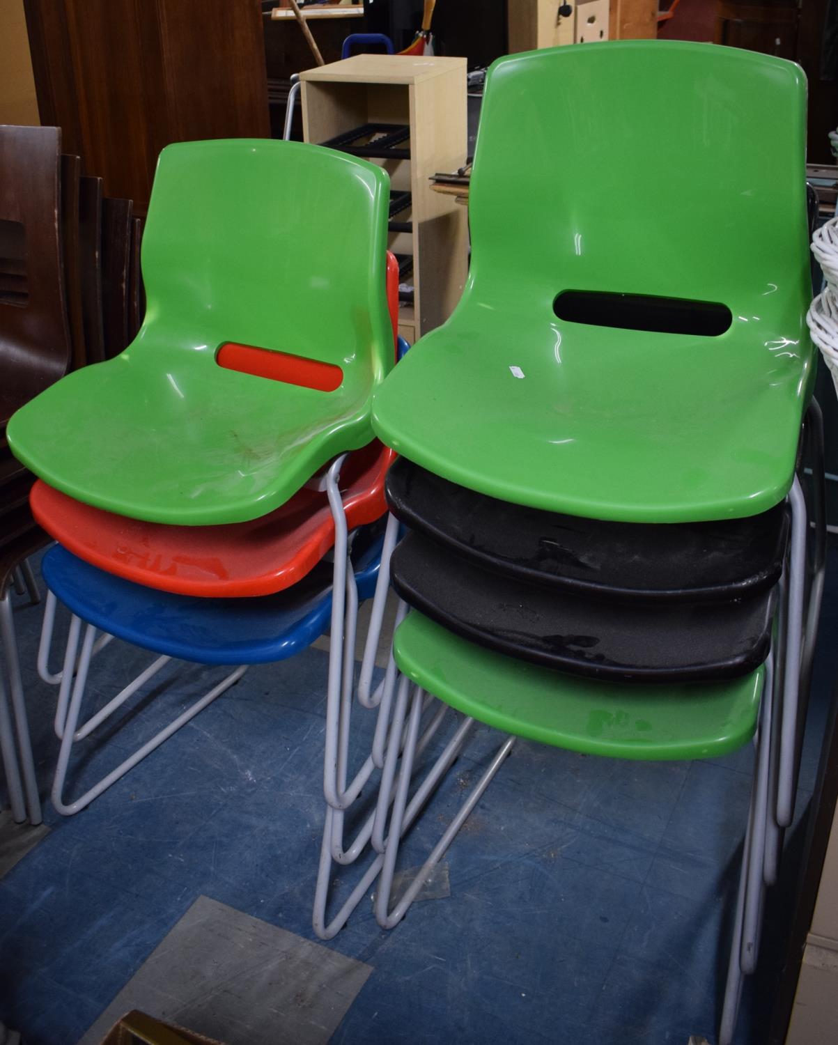 A Collection of Seven Modern Stacking Chairs