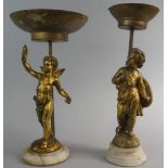 A Pair of Gilt Figural Stands in the Form of Cherubs, 36cm High