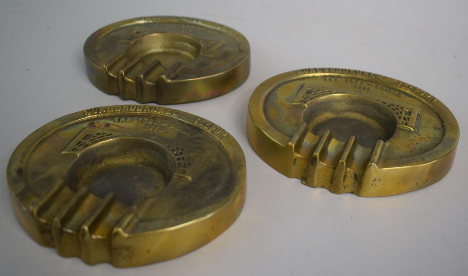 A Set of Three Cast Brass Coalbrookdale Oval Ash Trays Decorated with The Iron-Bridge 1779, Each