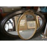An Oval Gilt Framed Wall Mirror, 56cm high and an Edwardian Oval Cushion Framed Wall Mirror, 82cm