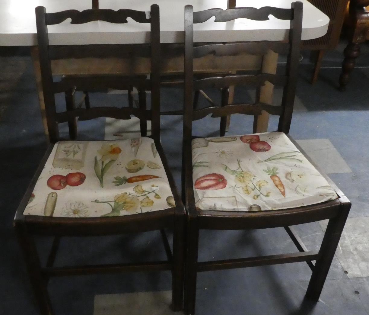 A Pair of Oak Ladder Back Dining Chairs