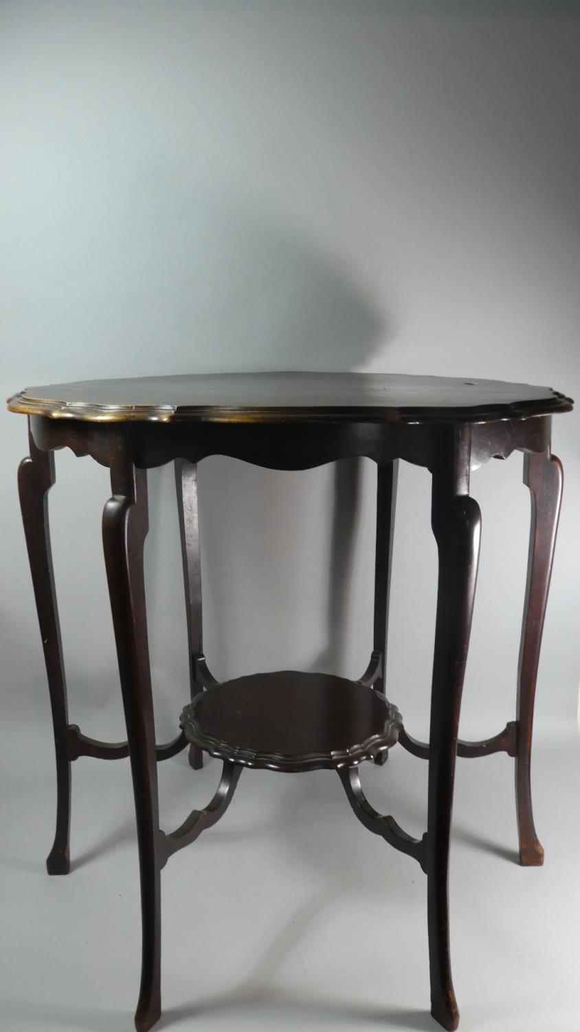 An Edwardian Mahogany Shaped Circular Occasional Table with Stretcher Shelf, 72cm Diameter