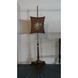 A 19th Century Mahogany Rise and Fall Pole Screen with Floral Needlework Panel