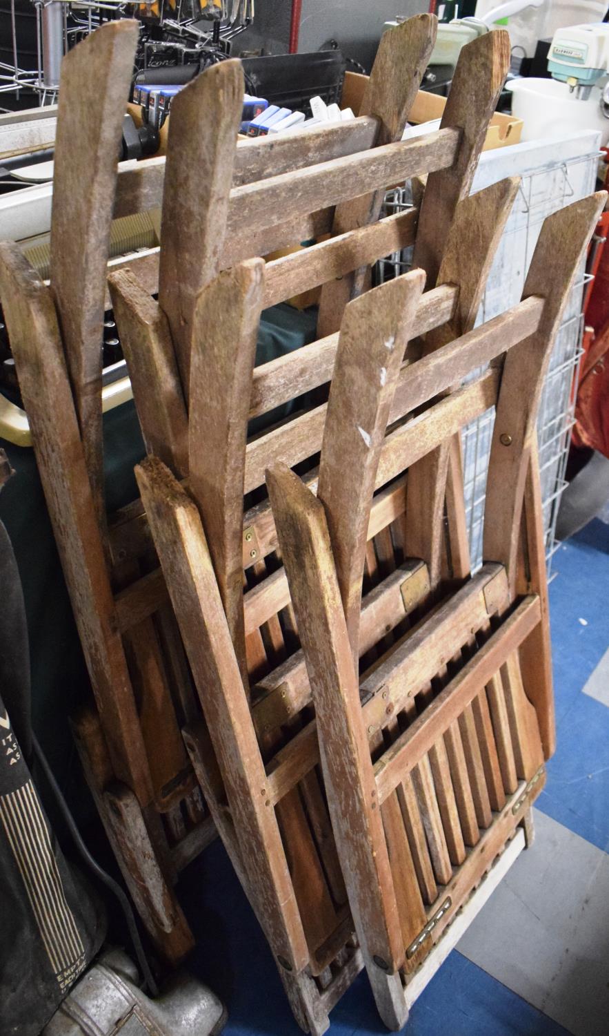 A Collection of Four Folding Wooden Garden Chairs