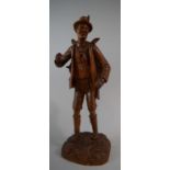 A Carved Black Forest Figure of Huntsman Carrying Stag on His Back. 45cm High