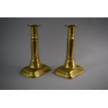 A Pair of Victorian Brass Rise and Fall Candlesticks on Rectangular Plinth Bases with Pushers.