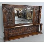 A Carved Oak Overmantle Mirror with Carved Panels and Carved Top Rail. Centre Shelf. 123cm Wide