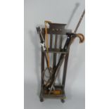 An Art Deco Oak Stick Stand Containing Riding Crop, Walking Sticks, Shooting Stick and Antler