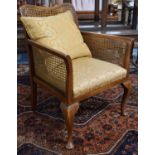 An Edwardian Walnut Framed Armchair on Cabriole Legs