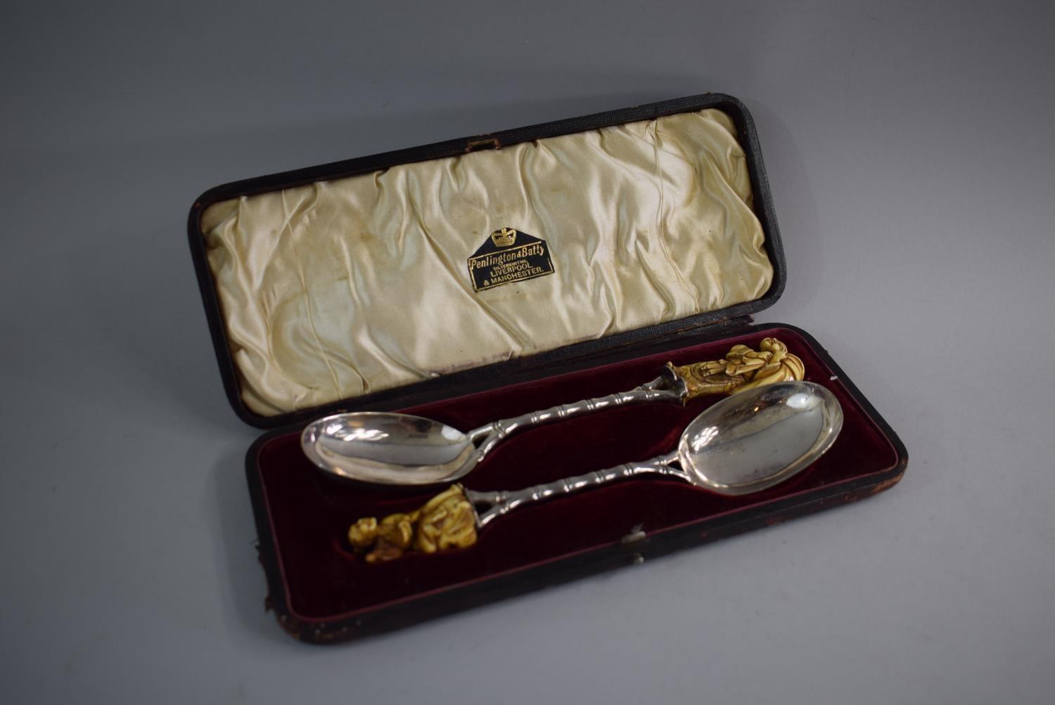 A Cased Pair of Oriental Ivory Mounted White Metal Serving Spoons with Faux Bamboo Handles and