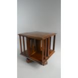 A Small 19th Century Revolving Bookcase with Parquetry Top, 32.5cms Square and 33cms High